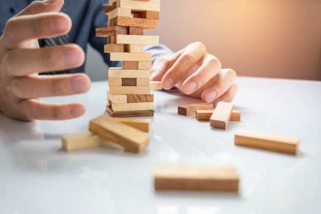 planning risk strategy business businessman gambling placing wooden block tower 1423 19