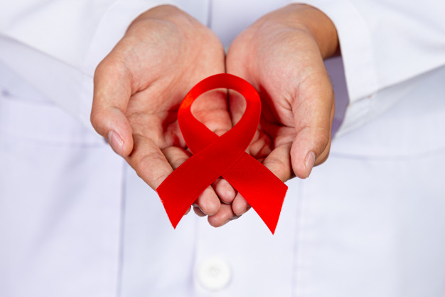 doctor holds red ribbon hiv awareness awareness world aids day world sexual health day 1150 24410
